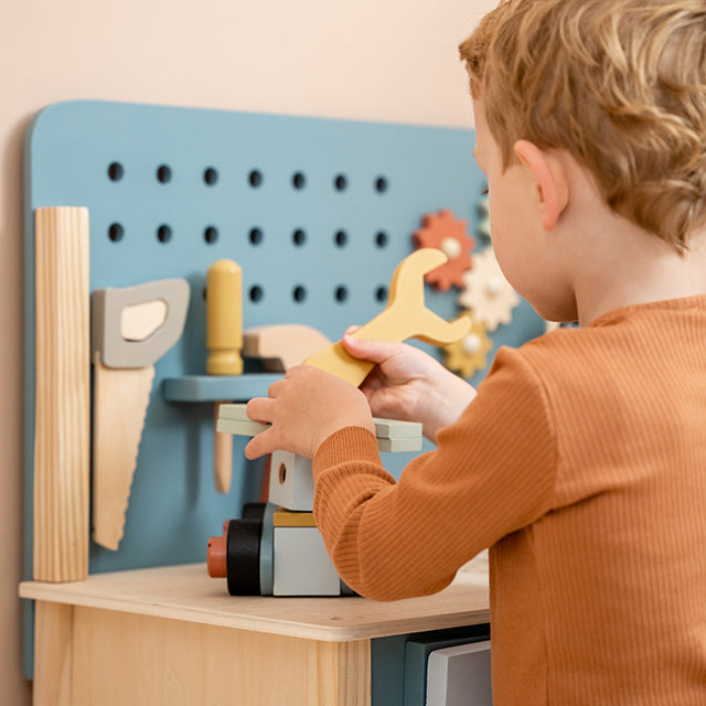 Zēns spēlējas ar bērnu darba rīku galdu ar instrumentiem Little Dutch 7079 Children's Workbench